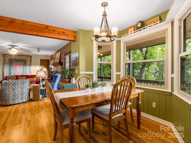 2981 Heath Peak Rd, Waynesville, NC 28785 - dining area with light wood-style flooring, a chandelier, beamed ceiling, and a ceiling fan