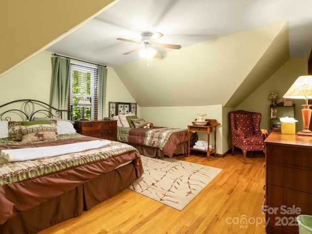 2981 Heath Peak Rd, Waynesville, NC 28785 - bedroom with light wood-type flooring, lofted ceiling, and ceiling fan