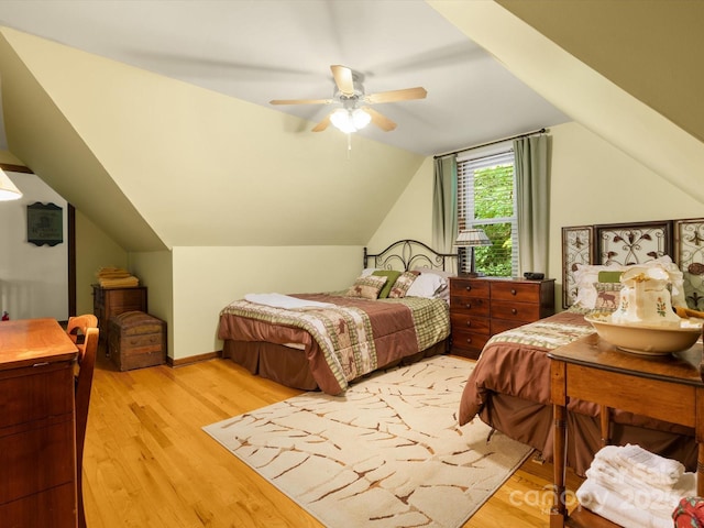 2981 Heath Peak Rd, Waynesville, NC 28785 - bedroom with light wood-style flooring, lofted ceiling, and a ceiling fan