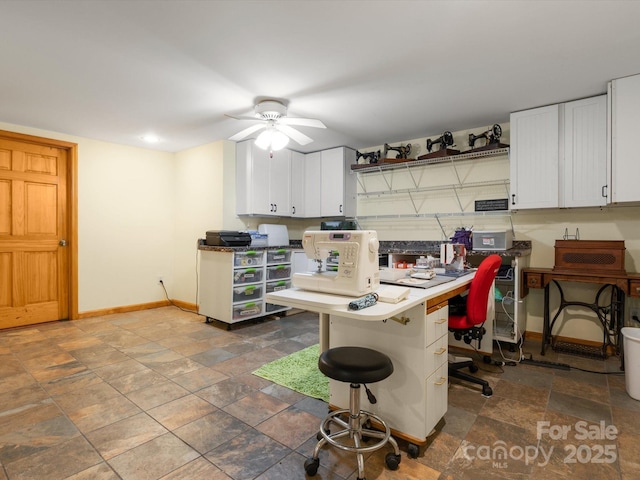 2981 Heath Peak Rd, Waynesville, NC 28785 - kitchen with ceiling fan, stone finish flooring, white cabinetry, a desk, and a breakfast bar area