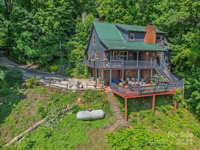 2981 Heath Peak Rd, Waynesville, NC 28785 - back of house featuring stairway, a chimney, a wooden deck, a metal roof, and stone siding