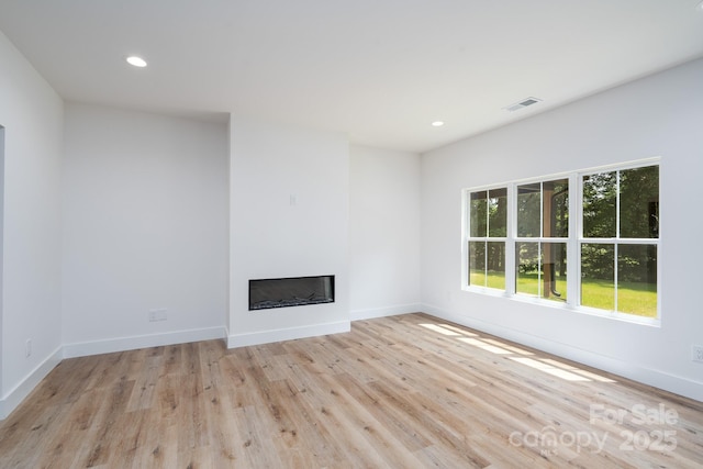 1524 Enochville Rd, Kannapolis, NC 28081 - unfurnished living room featuring a glass covered fireplace, light wood-style flooring, recessed lighting, and baseboards