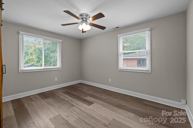 5008 Unaka Ave, Charlotte, NC 28205 - spare room with healthy amount of natural light, dark wood-type flooring, and ceiling fan