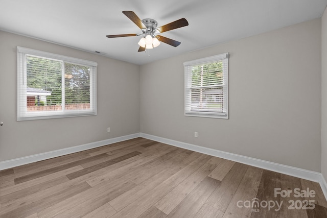 5008 Unaka Ave, Charlotte, NC 28205 - spare room featuring plenty of natural light, wood finished floors, and a ceiling fan