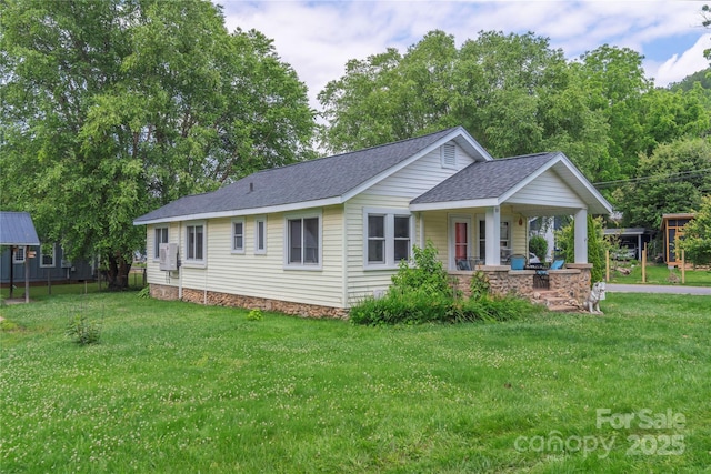 10 Poplar St, Waynesville, NC 28786 - single story home with a porch, a front yard, and a shingled roof