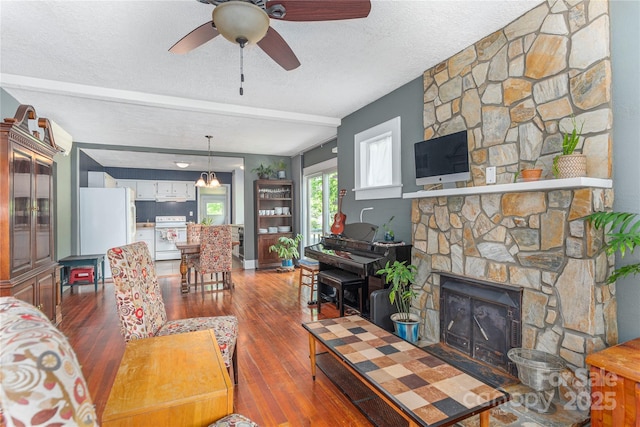 10 Poplar St, Waynesville, NC 28786 - living area with wood finished floors, ceiling fan, a fireplace, and a textured ceiling
