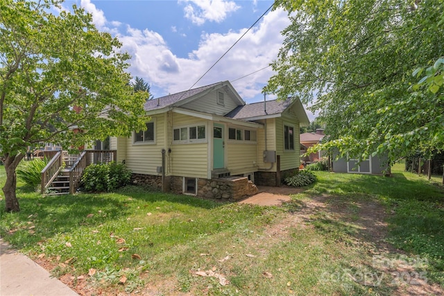 10 Poplar St, Waynesville, NC 28786 - view of side of home with a lawn, a deck, stone siding, and entry steps