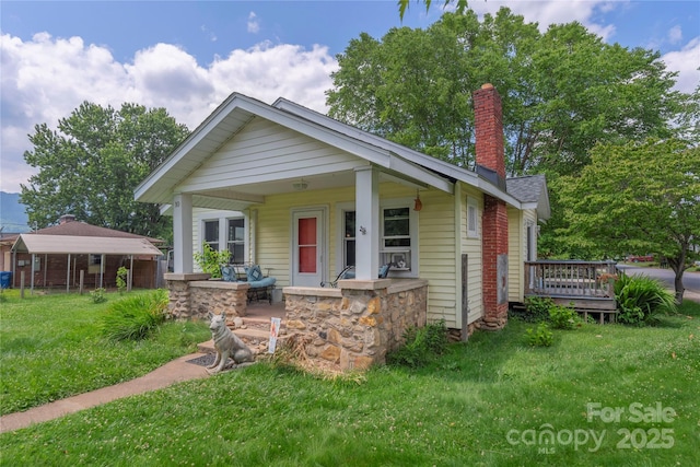 10 Poplar St, Waynesville, NC 28786 - bungalow-style home with a chimney, a porch, and a front yard
