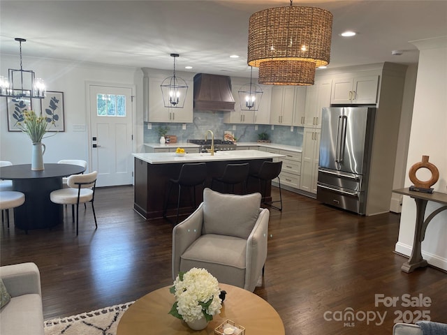 5840 Charing Pl, Charlotte, NC 28211 - kitchen featuring high end fridge, custom range hood, light countertops, a chandelier, and tasteful backsplash