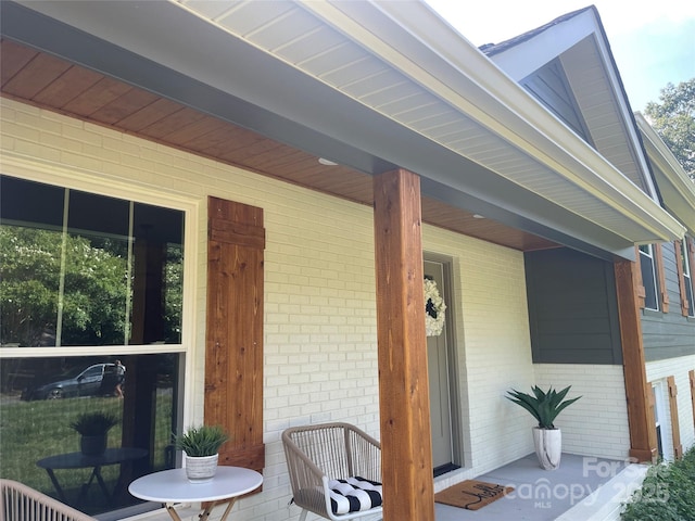 5840 Charing Pl, Charlotte, NC 28211 - view of exterior entry with brick siding and a porch