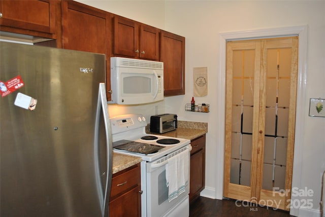 20 Foxden Dr Unit 203, Fletcher, NC 28732 - kitchen featuring white appliances, dark wood-type flooring, brown cabinets, and light stone countertops