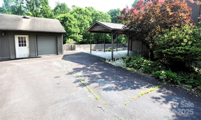 41 Balsam Shadows Rd, Maggie Valley, NC 28751 - view of patio featuring a garage, driveway, and an outbuilding