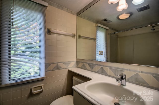 41 Balsam Shadows Rd, Maggie Valley, NC 28751 - bathroom featuring toilet, a shower, vanity, tile walls, and decorative backsplash