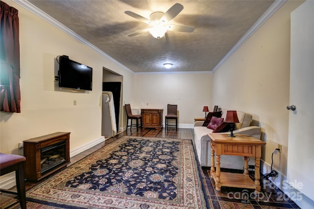 41 Balsam Shadows Rd, Maggie Valley, NC 28751 - living room with a ceiling fan, a textured ceiling, ornamental molding, baseboards, and dark tile patterned floors