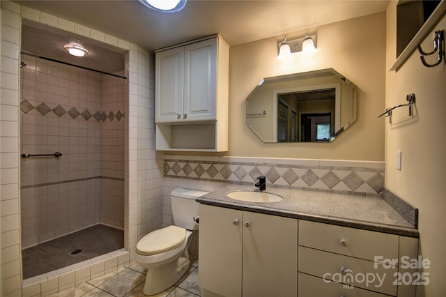 41 Balsam Shadows Rd, Maggie Valley, NC 28751 - bathroom with toilet, vanity, tiled shower, tile patterned flooring, and tile walls