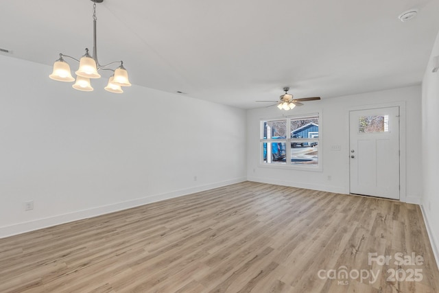 81 Kirk St, Salisbury, NC 28144 - unfurnished living room featuring light wood-style flooring, a ceiling fan, baseboards, and a chandelier