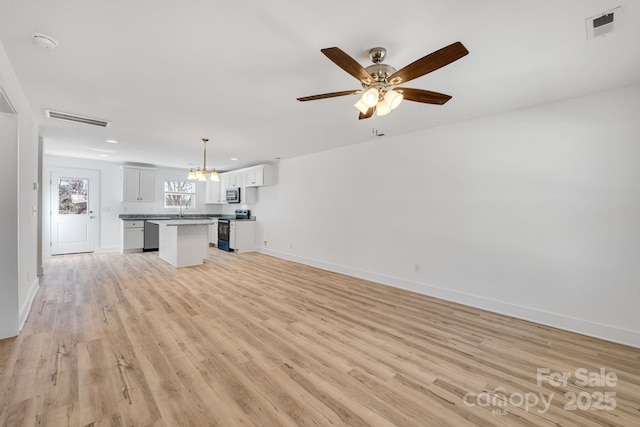 81 Kirk St, Salisbury, NC 28144 - unfurnished living room with light wood-style flooring, baseboards, a chandelier, recessed lighting, and a ceiling fan