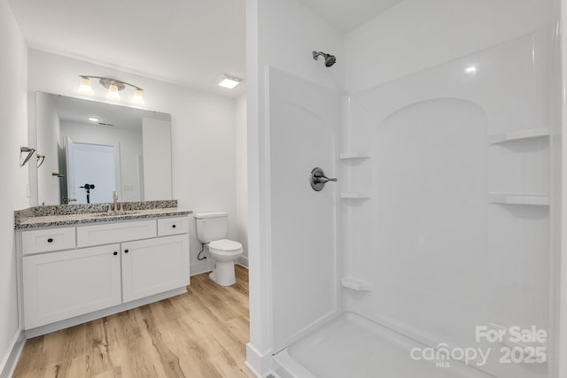 81 Kirk St, Salisbury, NC 28144 - bathroom featuring a shower, vanity, wood finished floors, toilet, and baseboards