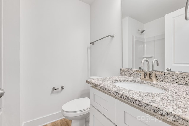 81 Kirk St, Salisbury, NC 28144 - bathroom featuring vanity, toilet, wood finished floors, baseboards, and a shower