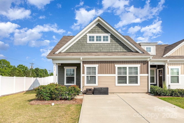 218 Canina Ln, Indian Trail, NC 28079 - view of front of house featuring board and batten siding, a shingled roof, and a patio