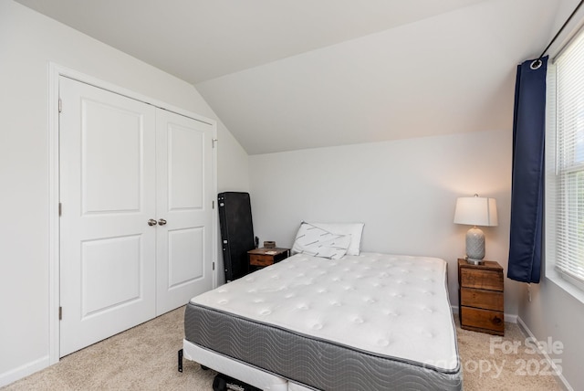 218 Canina Ln, Indian Trail, NC 28079 - bedroom featuring light colored carpet, vaulted ceiling, a closet, and baseboards