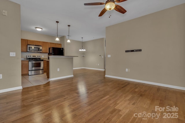 234 Brickton Village Cir Unit 201, Fletcher, NC 28732 - unfurnished living room featuring ceiling fan, light wood-style flooring, and a chandelier