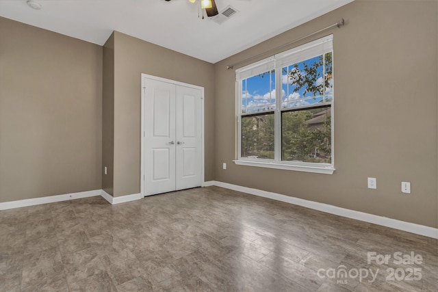 234 Brickton Village Cir Unit 201, Fletcher, NC 28732 - unfurnished bedroom featuring a closet and ceiling fan