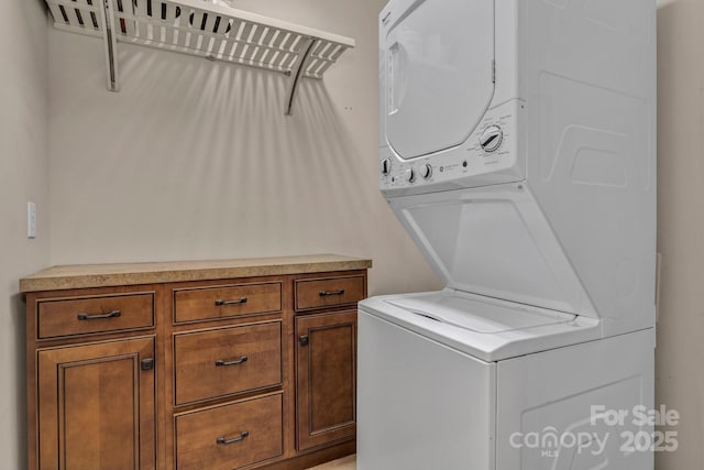234 Brickton Village Cir Unit 201, Fletcher, NC 28732 - laundry room featuring stacked washing machine and dryer and cabinet space