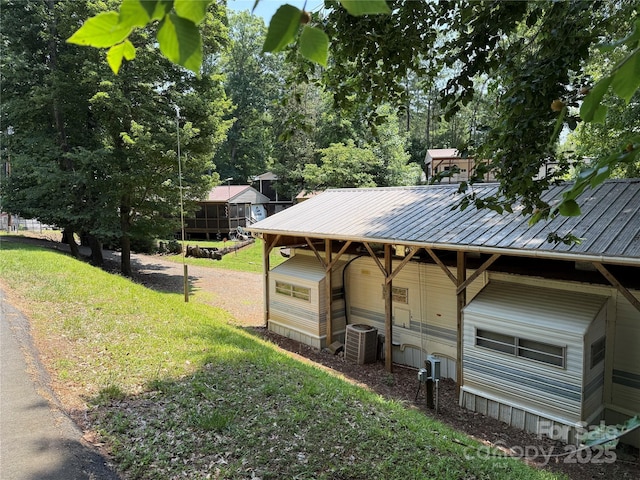104 Deer Park Rd Unit D143, Mount Gilead, NC 27306 - view of side of property featuring central air condition unit, metal roof, and a lawn