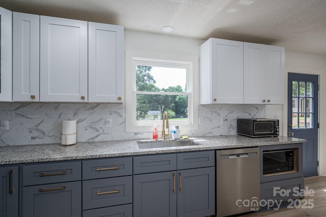 1256 Canseco Ln, Hickory, NC 28602 - kitchen with dishwasher, black microwave, a textured ceiling, white cabinets, and decorative backsplash
