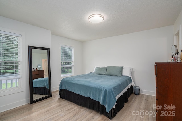 1256 Canseco Ln, Hickory, NC 28602 - bedroom featuring wood finished floors, multiple windows, and a textured ceiling