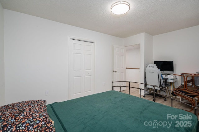1256 Canseco Ln, Hickory, NC 28602 - bedroom with wood finished floors, a closet, an office area, and a textured ceiling