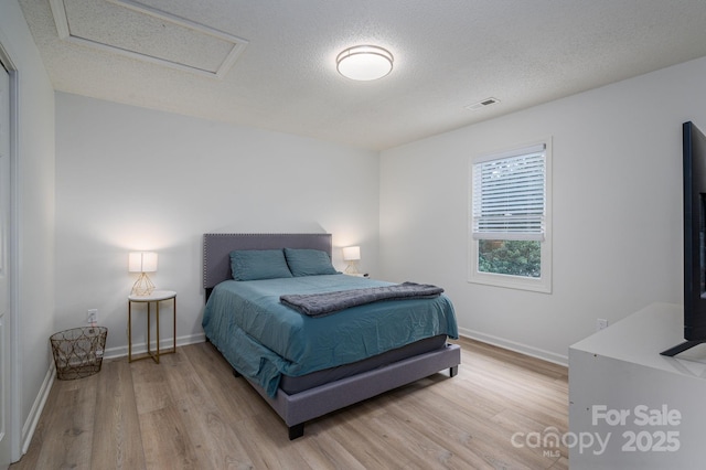 1256 Canseco Ln, Hickory, NC 28602 - bedroom featuring attic access, light wood-style flooring, and a textured ceiling