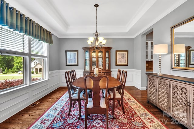 1600 Buckland Ct, Indian Land, SC 29707 - dining area featuring a chandelier, dark wood-type flooring, a raised ceiling, a wainscoted wall, and crown molding