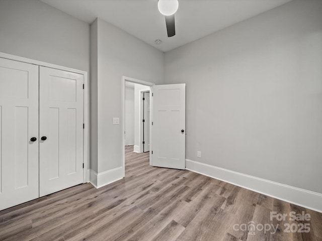 144 Walnut St, Chester, SC 29706 - unfurnished bedroom featuring wood finished floors, a closet, and a ceiling fan