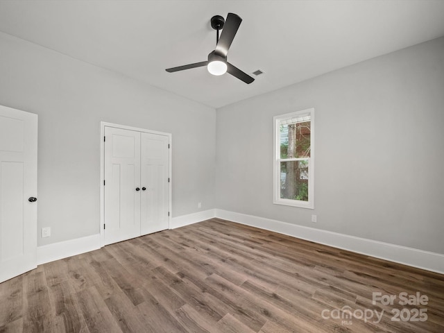 144 Walnut St, Chester, SC 29706 - unfurnished bedroom featuring wood finished floors, a closet, and ceiling fan