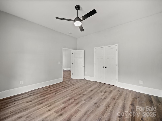 144 Walnut St, Chester, SC 29706 - unfurnished bedroom with a closet, wood finished floors, and a ceiling fan