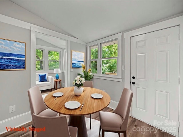 144 Walnut St, Chester, SC 29706 - dining space featuring vaulted ceiling and wood finished floors