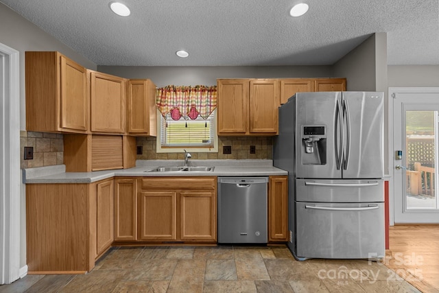 449 Concord Rd, Fletcher, NC 28732 - kitchen featuring stainless steel appliances, a sink, a textured ceiling, light countertops, and tasteful backsplash