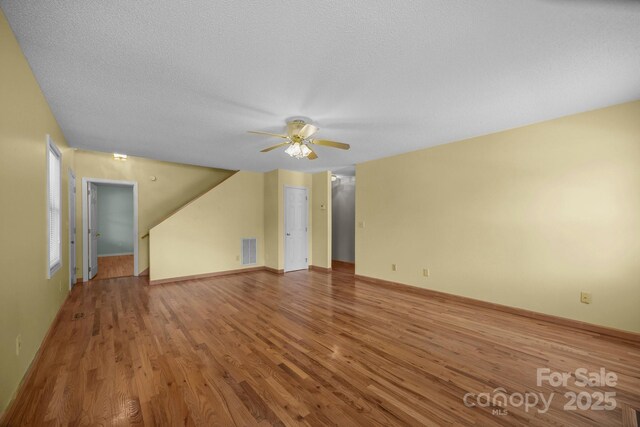 449 Concord Rd, Fletcher, NC 28732 - unfurnished living room with ceiling fan, wood finished floors, a textured ceiling, and baseboards