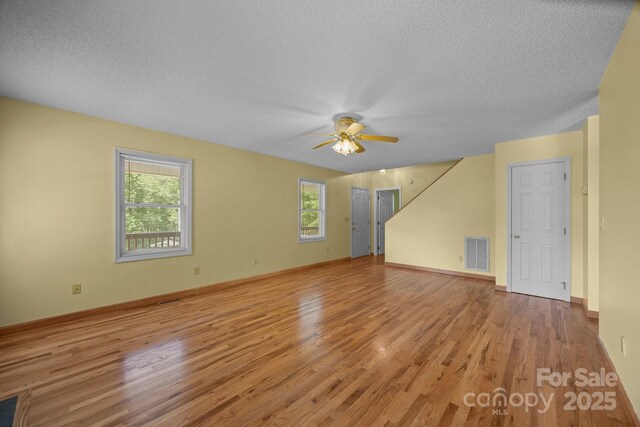 449 Concord Rd, Fletcher, NC 28732 - unfurnished room featuring light wood-type flooring, healthy amount of natural light, a textured ceiling, ceiling fan, and baseboards