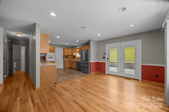 449 Concord Rd, Fletcher, NC 28732 - kitchen with stainless steel appliances, light wood finished floors, a textured ceiling, light countertops, and baseboards
