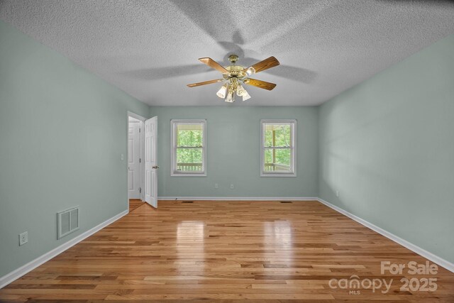 449 Concord Rd, Fletcher, NC 28732 - unfurnished room with a ceiling fan, light wood-style floors, a textured ceiling, and baseboards