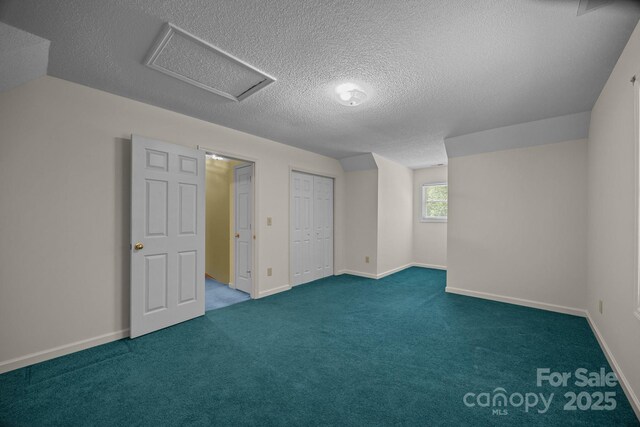 449 Concord Rd, Fletcher, NC 28732 - unfurnished bedroom featuring a textured ceiling, attic access, carpet flooring, and baseboards