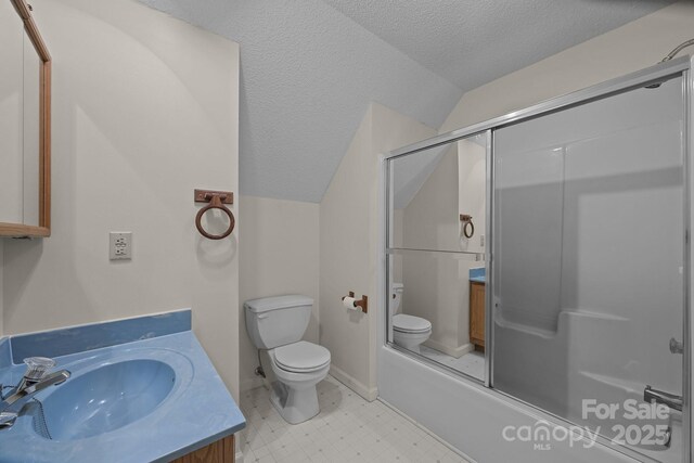 449 Concord Rd, Fletcher, NC 28732 - full bathroom featuring toilet, vaulted ceiling, vanity, bath / shower combo with glass door, and a textured ceiling