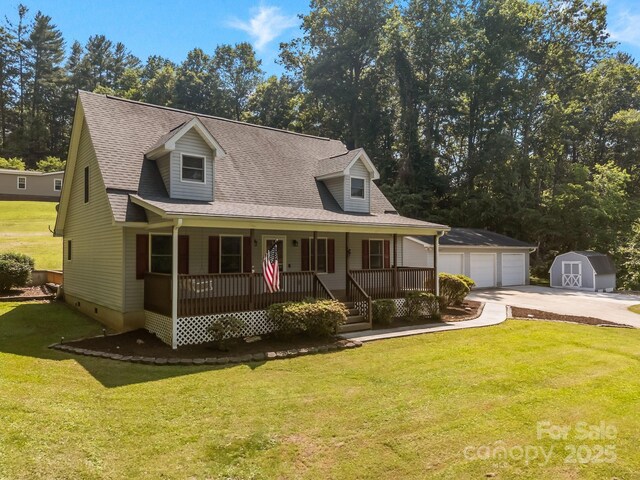 449 Concord Rd, Fletcher, NC 28732 - cape cod house with covered porch, a detached garage, a front yard, crawl space, and roof with shingles
