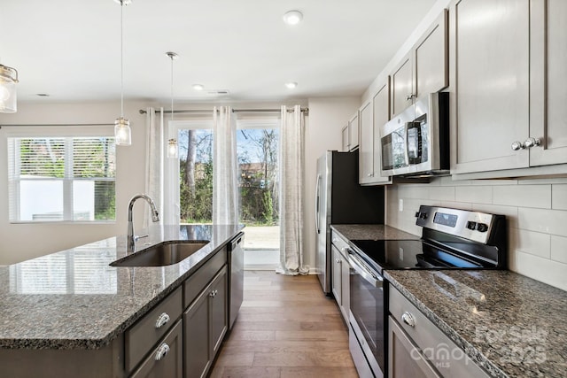 9142 Widden Way, Charlotte, NC 28269 - kitchen with stainless steel appliances, a sink, wood finished floors, healthy amount of natural light, and recessed lighting