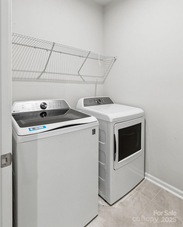 9142 Widden Way, Charlotte, NC 28269 - washroom with washer and dryer, light tile patterned floors, and baseboards