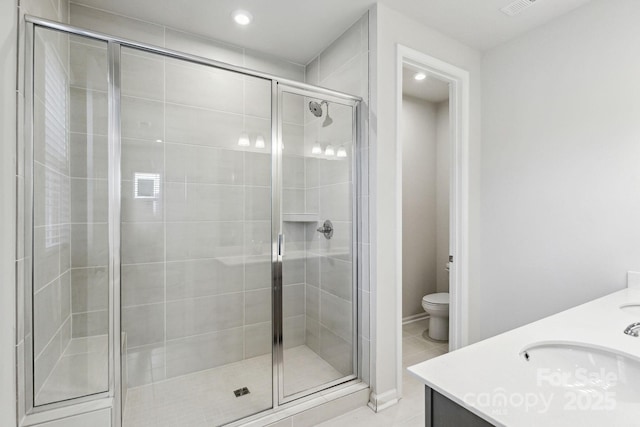 9142 Widden Way, Charlotte, NC 28269 - bathroom with vanity, a stall shower, toilet, and recessed lighting