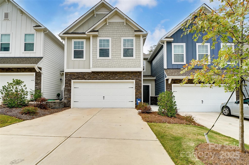 1133 Streamside Ln, York, SC 29745 - view of front of home with board and batten siding, stone siding, a garage, and concrete driveway